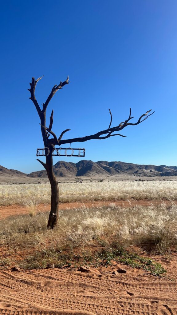 Zannier Sonop hotel entrance sign set against the rocky desert landscape of Namibia
