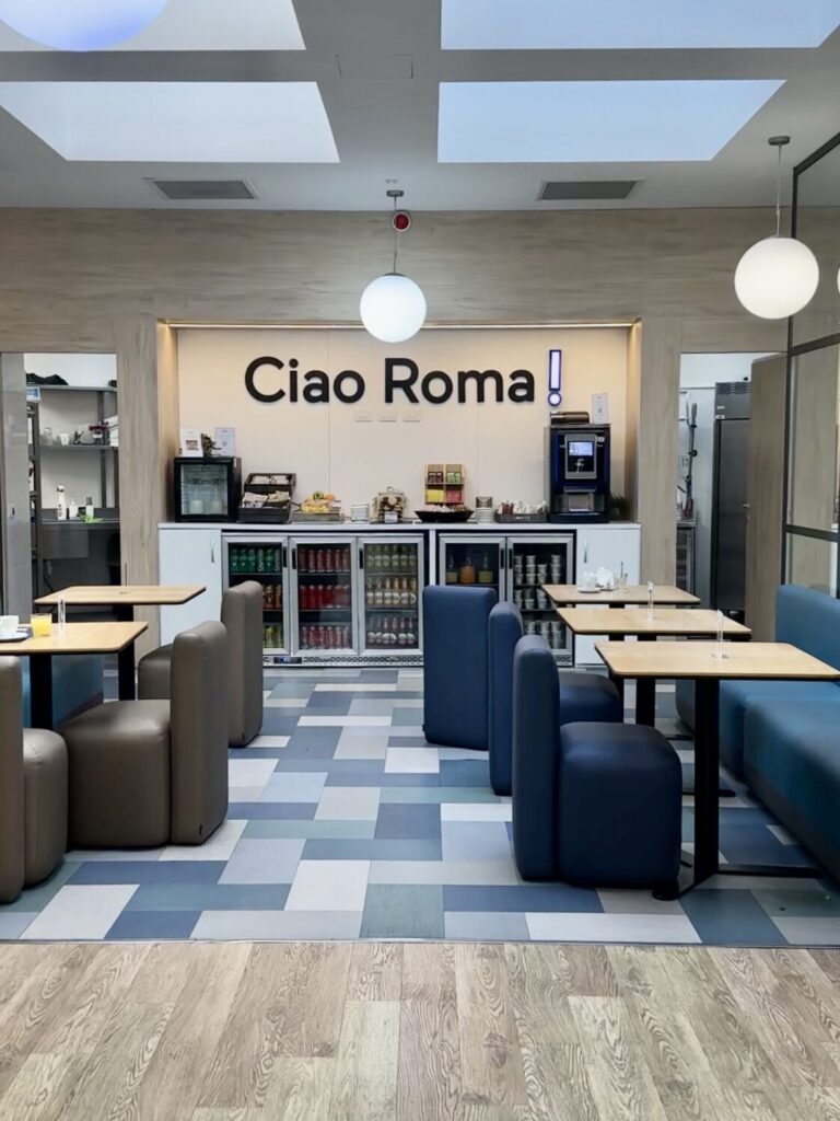 HelloSky lounge with blue seating and a Ciao Roma sign at Rome Fiumicino Airport